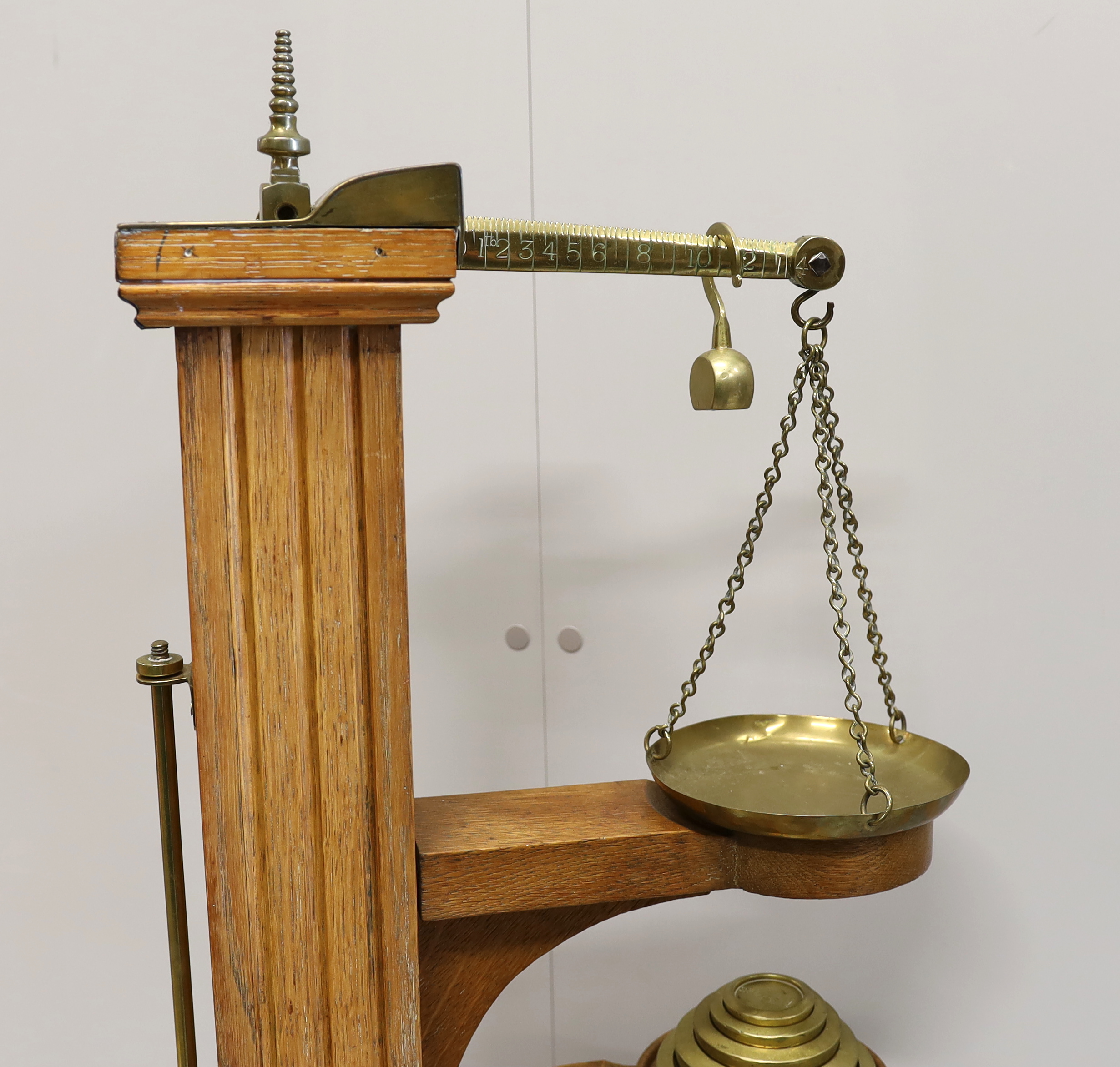 A Youngs of Bear St. London Victorian brass mounted oak personal weighing scales with incorporated height measuring stick, oak body and platform and set of five weights, 122cm